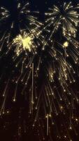 Vertical video - festive New Year celebration firework display background with exploding golden fireworks and shiny gold stars and particles.