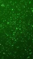 Vertical video - shiny glittering green stars and particles. Glitzy elegant celebration party animation. Suitable as an alternative abstract luxury Saint Patrick's Day background.
