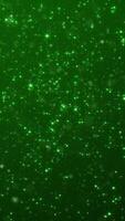 Vertical video - shiny glittering green stars and particles. Glitzy elegant celebration party animation. Suitable as an alternative abstract luxury Saint Patrick's Day background.