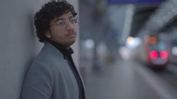 Lifestyle Portrait Of Young Man With Black Curly Hair Inside Train Station video