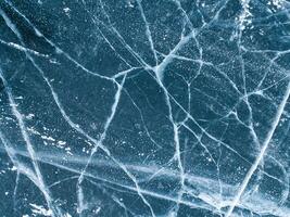 Beautiful cracks surface of the frozen lake of Baikal lake with frost methane bubbles in winter season. Baikal is the largest freshwater lake and the world's deepest lake. photo