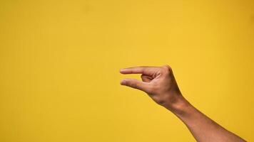 Men's hands with small gestures on a yellow background photo