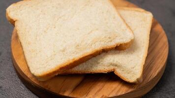 Slices of white bread on a wooden board photo