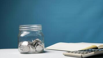 stack of coins in a clear transparent glass jar photo