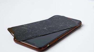 photo of smartphone with broken touchscreen display on white background