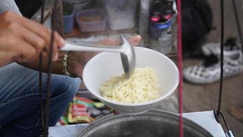 a bowl of meatballs complete with tofu and noodles, street vendors, typical street food from Bandung, West Java photo