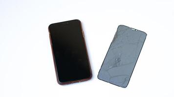 photo of smartphone with broken touchscreen display on white background