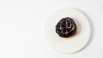 photo of donuts isolated in white background. Donuts with chocolate cream on top