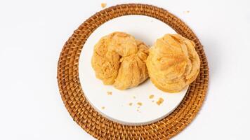 Freshly baked cream puffs or Vanilla eclairs isolated on white background photo