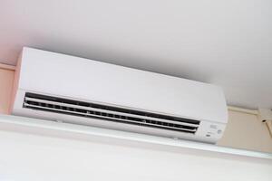 Inverter Air conditioner, Air conditioner inside the room on white wall photo
