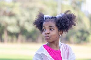 Child girl in the park, Cute little kid girl playing outdoors in the garden photo