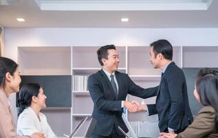 Success and happiness teamwork concept, Businessman handshake finishing up a meeting business partnership after a good deal photo