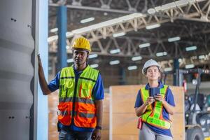 Workers team taking inventory in factory warehouse, Warehouse worker team checking containers box, Foreman workers working in warehouse talking about job photo