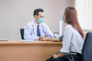 Doctor using sphygmomanometer checks blood pressure of a patient, doctor checking blood pressure photo