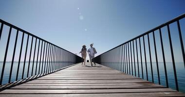 Two young people walking together on bridge road with lake view video