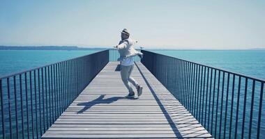 Young Man in Retro Vintage Style Walking on Bridge Road with Lake View video