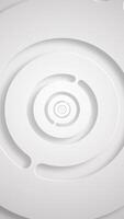 Vertical video - Elegant clean white abstract background with gently rotating concentric circles. This simple minimalist geometric background is full HD and a seamless loop.