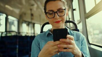 Public transport. Woman in tram using smartphone video