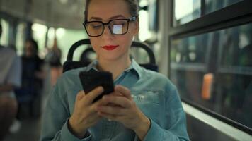 Public transport. Woman in tram using smartphone video