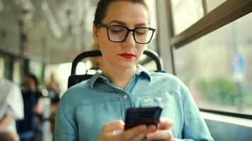 Public transport. Woman in tram using smartphone video