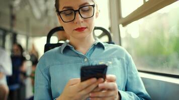 Public transport. Woman in tram using smartphone video