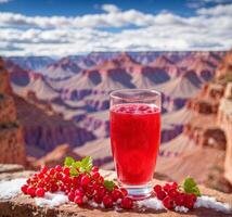 AI generated Red currant juice in a glass on the background of the Grand Canyon photo