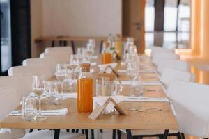 Empty dishes and cutlery on the table in the restaurant before dinner photo