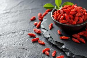 AI generated Fresh Goji berries on dark rough stone table. photo
