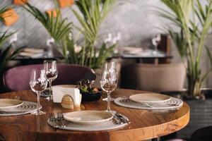 Empty dishes and cutlery on the table in the restaurant before dinner photo