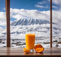 AI generated Glass of orange juice on a wooden table with view on Mt. Fuji photo