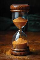 AI generated Stylish hourglass. Sand running in an hourglass, measuring the countdown time on a dark background photo
