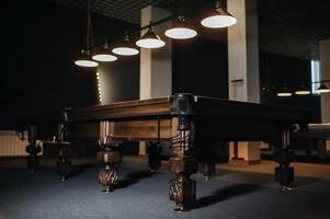 Oak unusual Billiard table in a billiard club.Bottom view photo