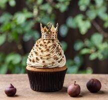 AI generated Cupcake with golden crown and chestnuts on wooden background. photo