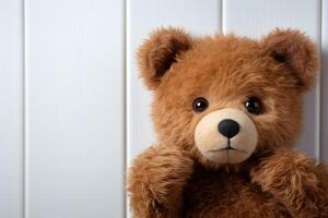 AI generated Surprise element Brown teddy bear plays peekaboo behind white door photo