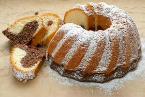 Traditional homemade marble cake. Sliced marble bundt cake on paper. photo