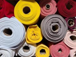 Samples of cloth and fabrics in different colors found at a fabrics market photo