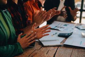 Cheerful business colleagues applauding in meeting at coworking office photo