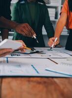 Male mature caucasian ceo businessman leader with diverse coworkers team, executive managers group at meeting. Multicultural professional businesspeople working together on research plan in boardroom. photo