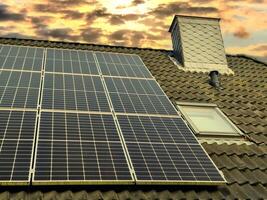 Solar panels producing clean energy on a roof of a residential house photo