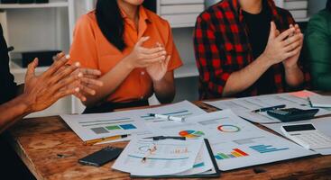 Cheerful business colleagues applauding in meeting at coworking office photo