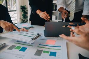 Business team working with new startup project plan and discussion information for financial strategy with laptop and digital tablet in a modern business lounge. photo