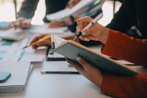 Business team working with new startup project plan and discussion information for financial strategy with laptop and digital tablet in a modern business lounge. photo