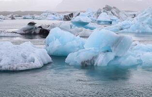 Iceland, Jokulsarlon Lagoon, Turquoise icebergs floating in Glacier Lagoon on Iceland. photo