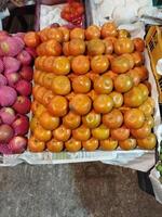 a display of tomatoes and other fruits at a market photo