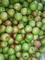 a bunch of green apples on a table photo