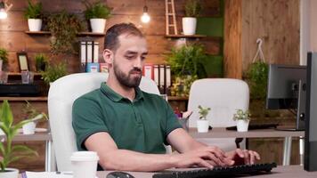 Office worker in casual clothes works on the computer. Zoom in slow motion shot video