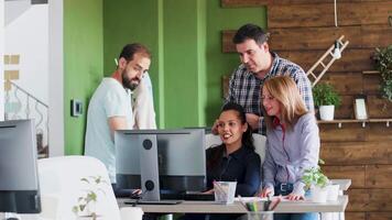 Happy young business people about their new data analysis. Coworkers helping each other. video