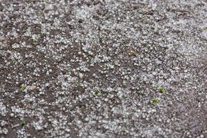 granizo de hielo blanco en la superficie de la carretera asfaltada foto