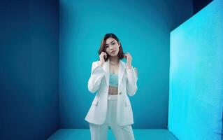 AI generated Asian beautiful business women standing isolated on blue background. Generative AI photo
