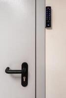 gray metal door with black handle and digital touch sensor RFID lock photo